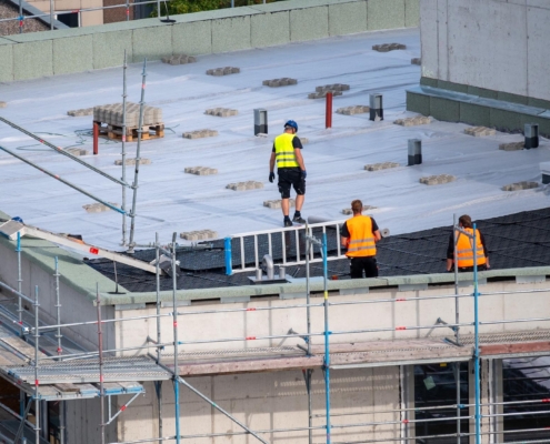 People Working On Flat White Roof