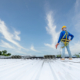 A Roofer Using Electric Drill Nail Gun Installing Pu Foam Roof Sheet At Under Construction